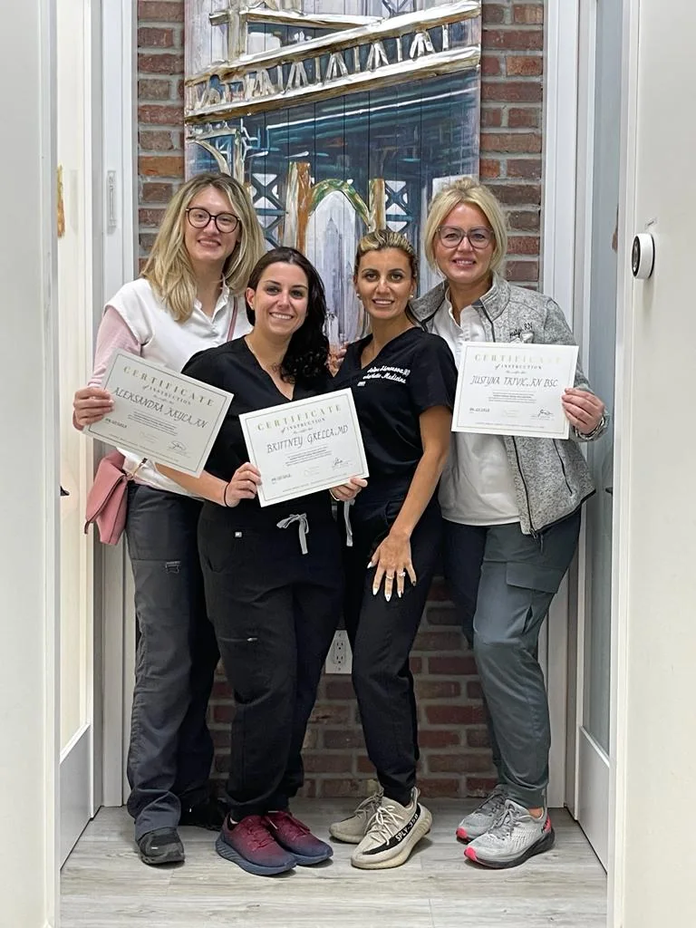 Sofiya Shimonova, NP with four medical professionals holding certificates of instruction after completing injectable training at Contour Aesthetics